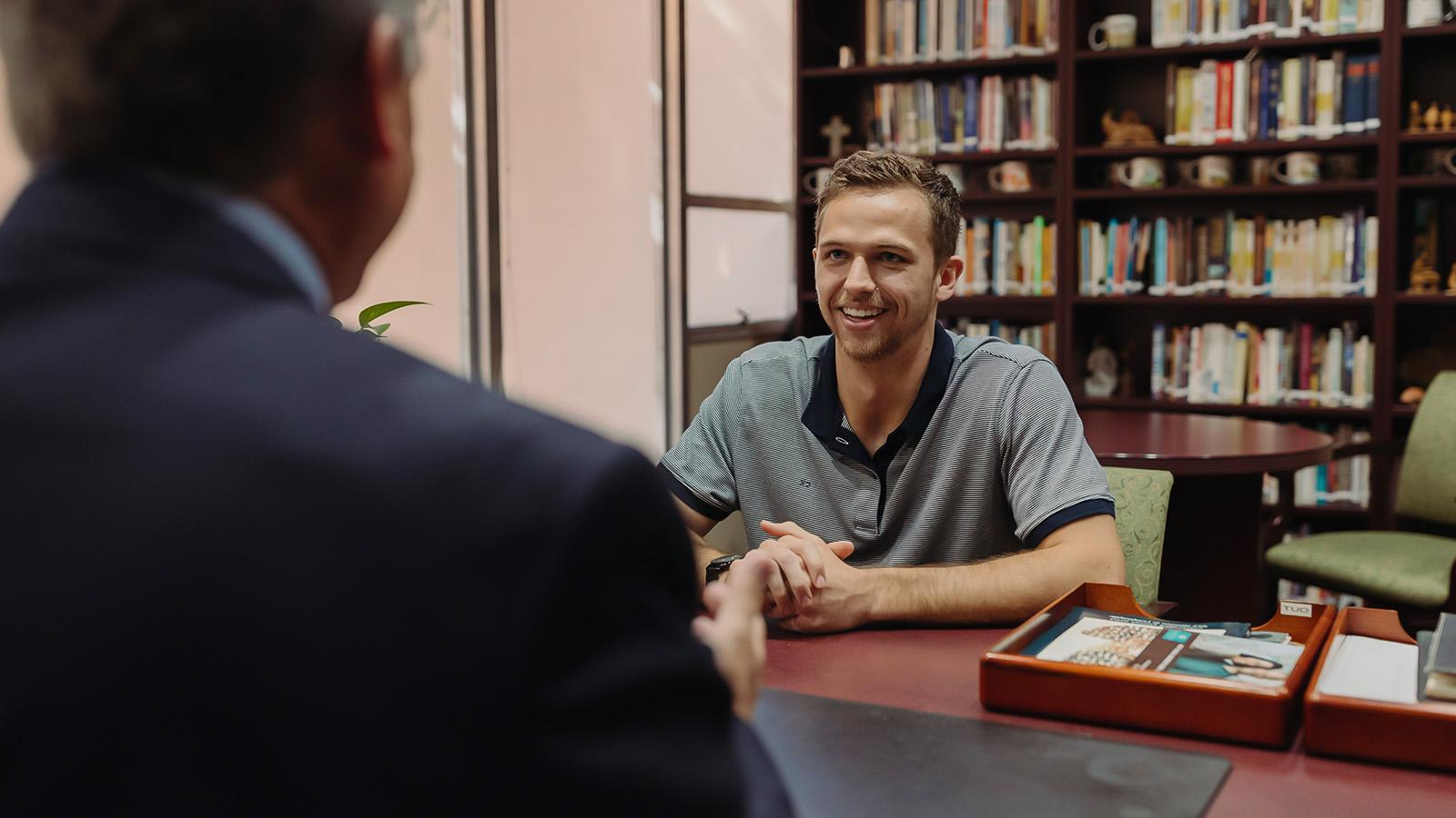 PBA student engages in discussion with an instructor.